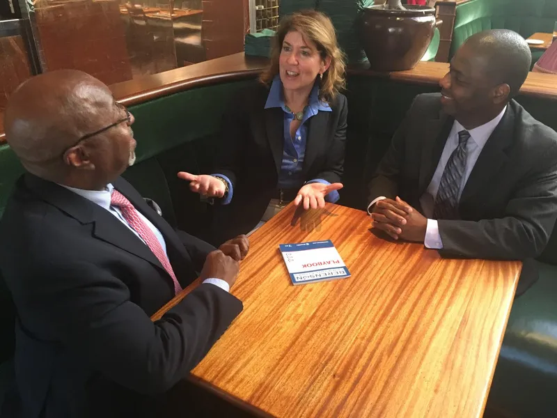 Heidi Berenson coaching two executives at a table