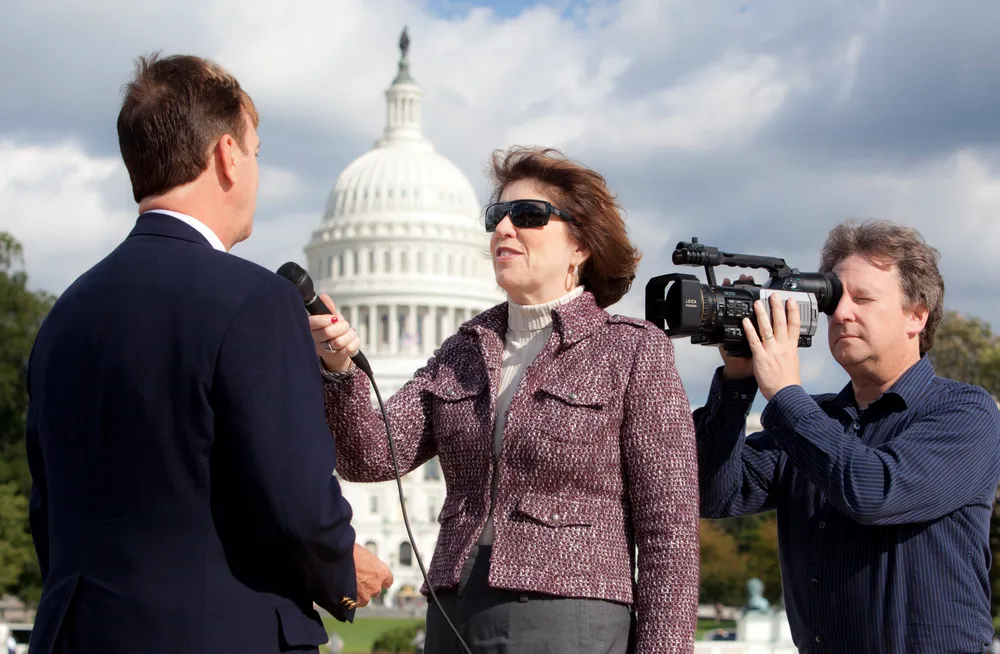 Heidi Berenson interviewing a client in front of the U.S. Capitol